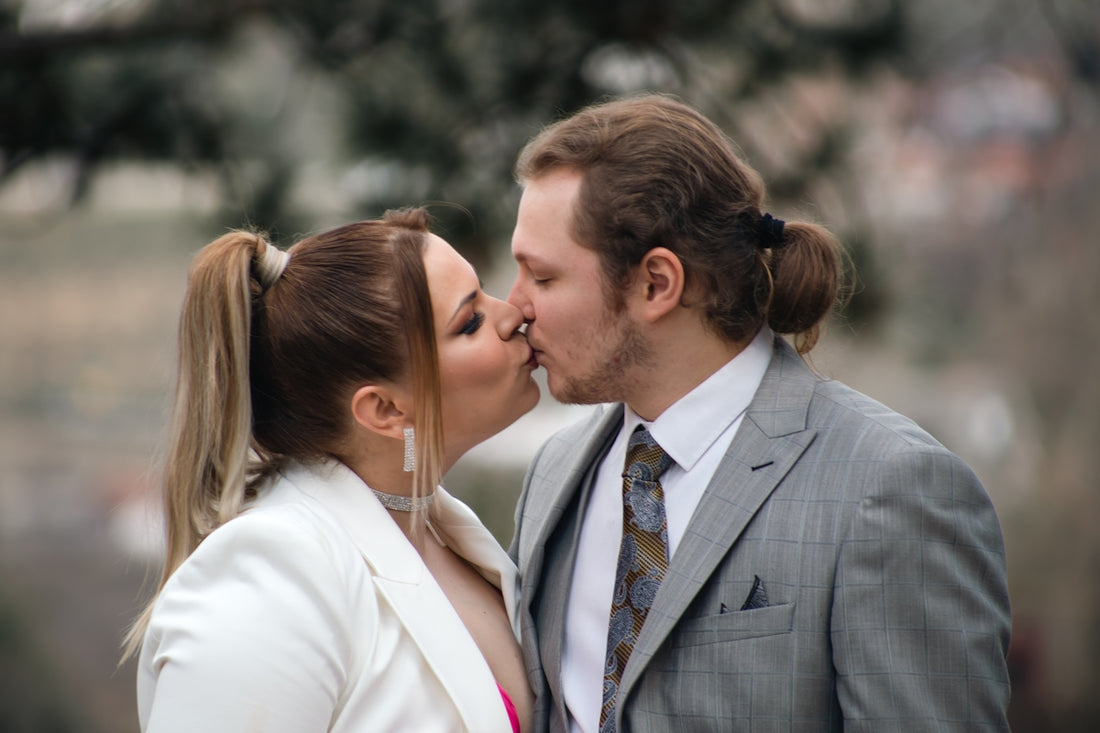 a man and a woman kissing each other