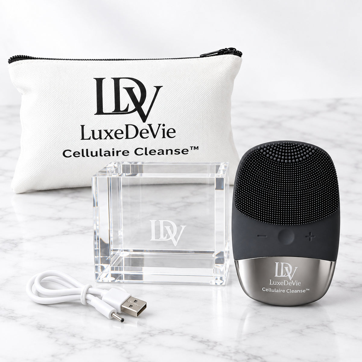 Black LuxeDeVie Cellulaire Cleanse Signature device with engraved clear acrylic Signature Cradle, white Cellulaire Cleanse Travel Tote and charging cable.